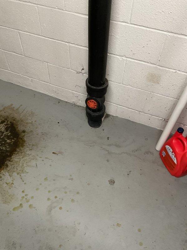Responded to main drain backup in basement. Located cleanout access point on vertical black PVC drainage stack. Cleared obstruction from main sewer line using appropriate drain cleaning equipment. Verified proper drainage flow restored throughout system. Inspected visible plumbing infrastructure including drainage pipes and fittings to ensure no additional issues present. System tested and confirmed operational with no further backup occurring.