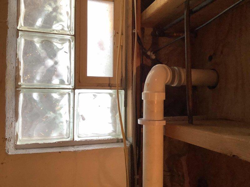 Completed comprehensive plumbing repair proposal addressing multiple systems throughout the residence. Kitchen work included correcting improperly roughed-in drain with excessive 90-degree fittings creating exaggerated trap, replacement of tubular waste assembly, garbage disposal, and basket strainer, repair of leaking cold supply copper line, and installation of new straight stops for dishwasher and kitchen faucet hot/cold supplies. Installed 1/2" gas line from existing 1x1/2" tee near furnace to kitchen for gas stove conversion, including provisions for 120V outlet. Replaced non-functional aging RO system in basement. Replaced corroded back hose bib and isolation valve, including new stop and tee for RO connection. Installed 1/2" gas line to laundry room for gas dryer by tying into existing line above water heater, verified electrical 120V outlet requirements. Addressed dishwasher leak manifesting in basement ceiling, traced to failed 2" ABS kitchen drain line connection resolved thr