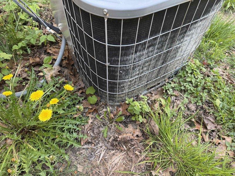 Completed preventative maintenance tune-up on residential outdoor condensing unit. Performed standard system diagnostics including electrical measurements, verified compressor amperage at 9.41A within normal operating parameters, and inspected all accessible components. Unit operational with no immediate deficiencies noted, though vegetation encroachment around equipment base should be addressed by homeowner to maintain proper airflow clearance.