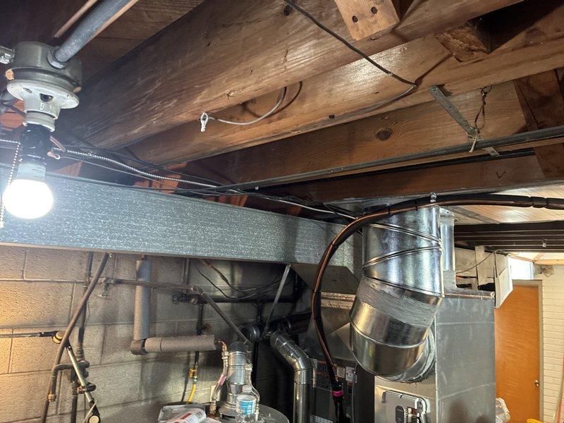 Installed dedicated electrical circuits for new air conditioning and furnace equipment in utility room. Ran metallic conduit from main electrical panel through ceiling joists to equipment locations, terminated connections at new breakers, and ensured all wiring met current NEC code requirements for HVAC installations.