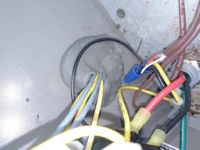 Completed preventive maintenance on residential air conditioning system. Inspected electrical connections at outdoor condensing unit, verified proper wire routing and terminations, and documented equipment condition. All electrical components found secure with no immediate safety concerns noted, though unit exterior shows normal weathering from environmental exposure.