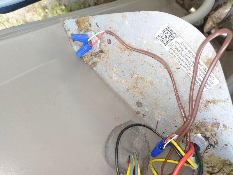 Completed preventive maintenance on residential air conditioning system. Inspected electrical connections at outdoor condensing unit, verified proper wire routing and terminations, and documented equipment condition. All electrical components found secure with no immediate safety concerns noted, though unit exterior shows normal weathering from environmental exposure.