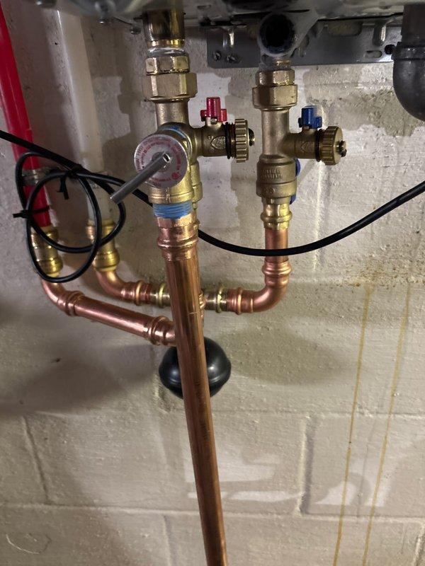 Completed tankless water heater replacement, removing existing unit and installing new Rinnai tankless system. Installation included mounting unit to wall, connecting copper water supply lines with brass shut-off valves and pressure gauge, routing PVC exhaust venting through ceiling, connecting yellow flexible gas line, and establishing electrical connections. System tested and operational at 120 degrees, with all connections verified for proper function and leak-free operation.