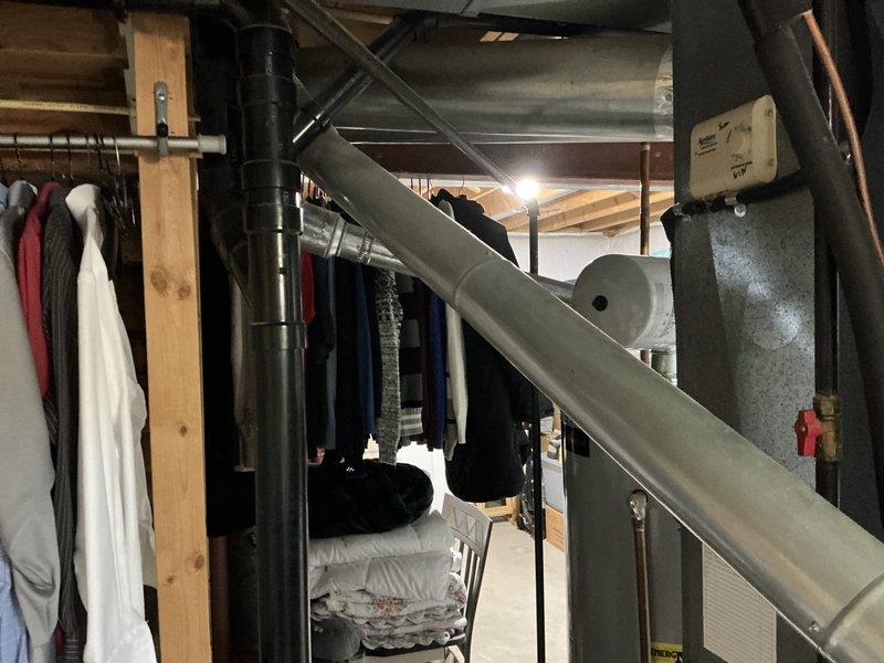 Conducted comprehensive HVAC system assessment and provided replacement estimate for 20-year-old furnace with cracked heat exchanger. Documented existing Carrier furnace installation in basement utility area, including associated ductwork, air handler components, and ventilation systems. Quote prepared for furnace and air conditioning replacement with BOGO promotion, including duct cleaning services, with detailed photographic documentation of current system configuration and heat exchanger failure.