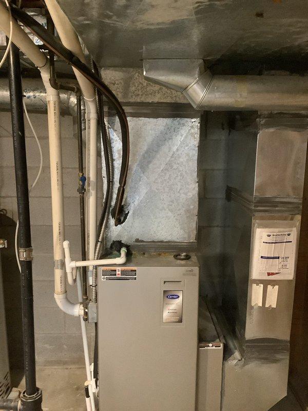 Completed installation of new Carrier air conditioning system including outdoor condenser unit and indoor evaporator coil with air handler. Condenser unit was positioned on concrete pad against exterior wall with proper clearances, refrigerant lines were run and insulated, and all electrical connections were made to manufacturer specifications. Indoor air handler with integrated coil was installed in basement mechanical room, connected to existing ductwork with new plenum and filter housing, and all drain lines were properly routed using PVC piping. System was charged with refrigerant, tested for proper operation, and verified all components are functioning correctly with optimal airflow and temperature differential.