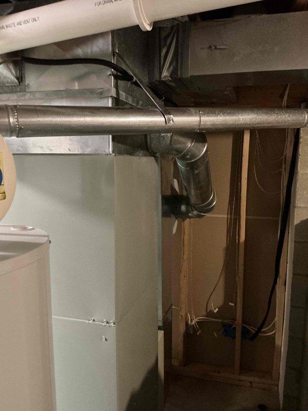 Provided comprehensive replacement estimate for existing 12-13 year old Trane furnace system located in basement utility area. Unit was previously diagnosed by technician and documented with detailed photography showing complete HVAC installation including furnace, Aprilaire humidifier, associated ductwork, and PVC venting system. Estimate covers full system replacement with updated equipment to restore reliable heating operation.