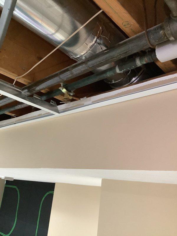 Replaced aging refrigerator waterline in 1981-built residential property. Accessed supply lines through ceiling cavity between floor joists, removing section of ceiling panel to expose existing plumbing infrastructure. Disconnected original waterline, which showed signs of deterioration consistent with 45-year-old building systems. Installed new supply line with proper fittings and connections, routing through existing joist spaces alongside HVAC ductwork and drainage systems. Verified all connections for proper seal and tested water flow to refrigerator. Confirmed no leaks at connection points or along new line. Restored ceiling access panel and cleaned work area. System operating properly with adequate water pressure and flow rate to appliance.