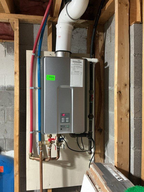 Responded to service call for 11-year-old natural gas tankless water heater displaying error code 12. Upon inspection, identified that error code 12 indicates a flame failure issue, which prevented the unit from igniting properly. Performed diagnostic testing of the ignition system, gas supply, and venting components. Verified proper gas pressure at the unit and confirmed adequate combustion air supply. Inspected the exterior vent termination at the building foundation to ensure proper clearance and no obstructions blocking exhaust discharge. Documented equipment condition with photos showing the wall-mounted installation with PEX supply lines, copper gas connections with shut-off valves, and PVC venting system. Unit remains operational following troubleshooting procedures.