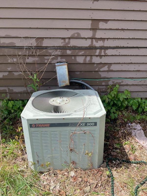 Responded to no-cooling complaint on approximately 40-year-old Trane XE 900 air conditioning system. Upon arrival, performed visual inspection of outdoor condensing unit, which exhibited significant age-related deterioration including extensive rust, corrosion, and weathering on cabinet panels. Connected manifold gauge set to service ports to assess refrigerant pressures and system operation. Due to advanced age of equipment and observed condition, recommended system replacement rather than repair, as unit has far exceeded typical service life expectancy and replacement parts are no longer readily available for this vintage model.