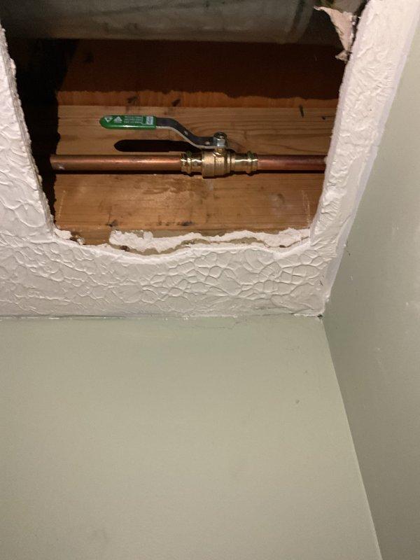 Responded to service call for malfunctioning outdoor spigot. Upon inspection, determined existing hose bibb was not frost-proof and required replacement to prevent freeze damage. Installed new frost-proof sillcock with proper extension through wall cavity to place shut-off valve inside conditioned space. Cut access opening in interior ceiling to facilitate installation and ensure valve placement met code requirements. Connected new copper supply line to existing plumbing infrastructure using brass ball valve for reliable shut-off capability. Verified proper pitch on exterior spigot for complete drainage when closed. Tested system for leaks and confirmed full operational functionality of new frost-proof installation.