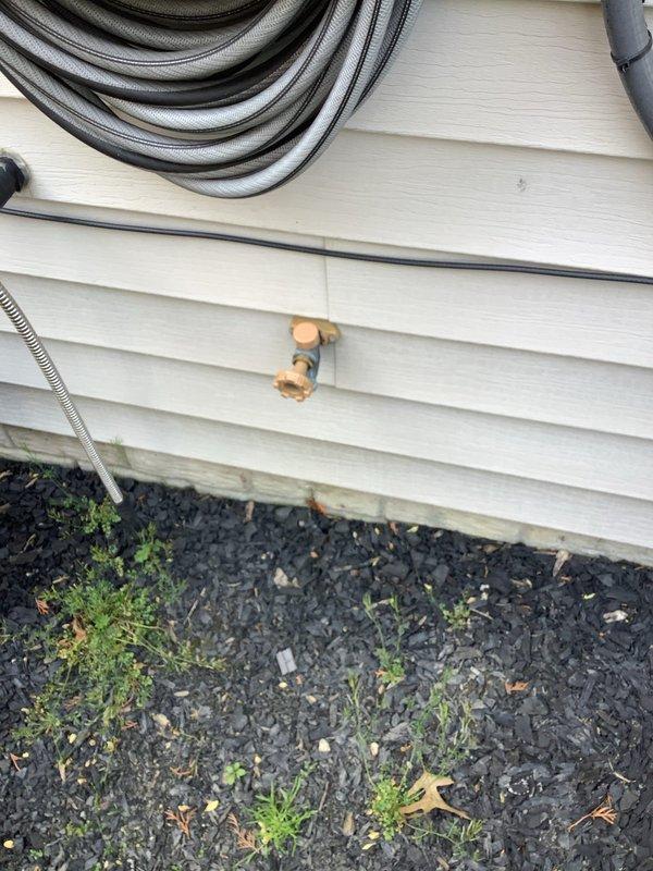 Responded to service call for malfunctioning outdoor water spigot with active water leak. Upon arrival, found existing hose bib continuously flowing water due to failed internal valve mechanism. Shut off water supply at main line to prevent further water waste and potential property damage. Removed deteriorated copper spigot assembly from exterior wall mounting point. Installed new frost-free hose bib with proper sealing and secure attachment to existing copper supply line. Restored water main, tested new fixture for proper operation and verified no leaks at connection points or valve seat.