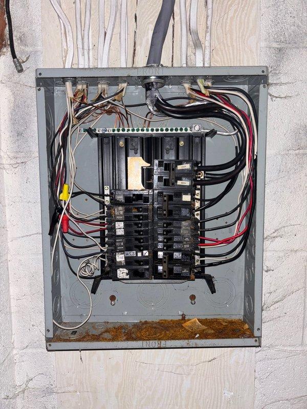 Completed installation of 18kW standby generator system with 100-amp automatic transfer switch. Ran 15 feet of gas line from existing supply to generator location and 20 feet of electrical conduit to connect unit to transfer switch panel. Transfer switch was mounted on plywood backing and wired to main electrical panel, with all circuits properly distributed across dual bus bars and secured with appropriate wire management. Gas piping includes shut-off valve and proper fittings to ensure code-compliant fuel delivery to generator unit.
