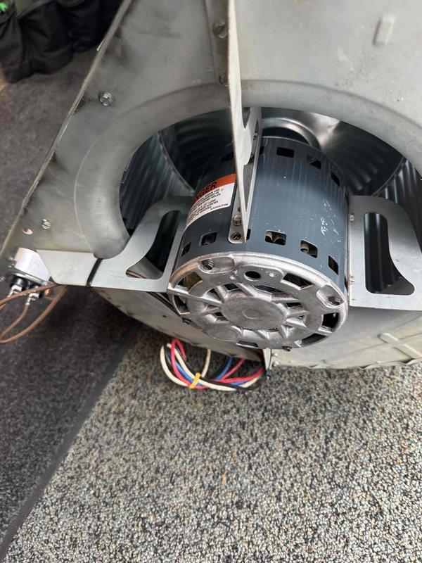 Replaced failed blower motor and wheel assembly in HVAC system. Removed old motor from squirrel cage housing, installed new motor with proper electrical connections including multi-conductor wiring to terminal block and contactors, and tested system operation to verify proper airflow and function.