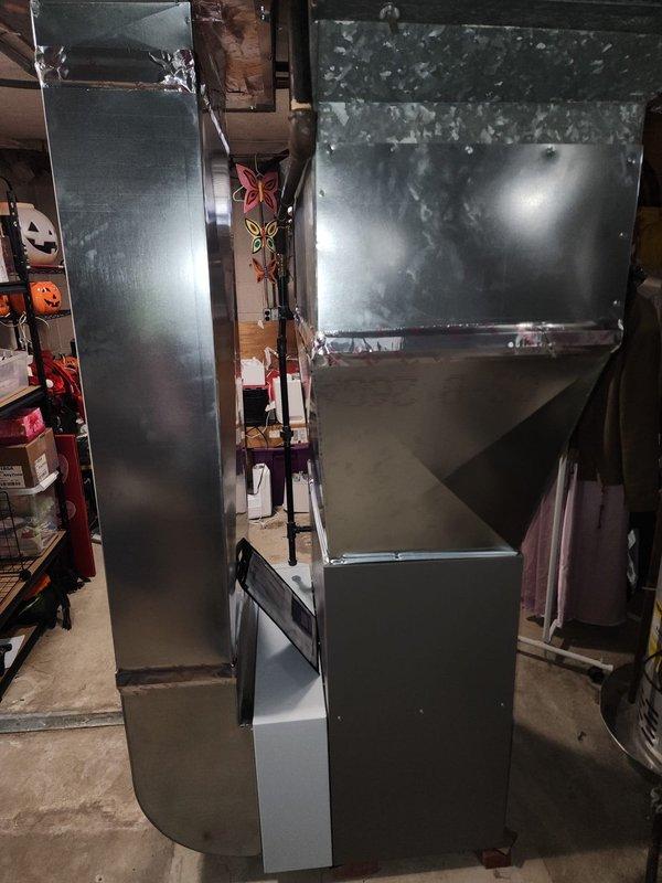 Completed second-stage installation of high-efficiency 90% AFUE furnace system in residential basement. Installed new furnace unit with PVC venting, connected to vertical sheet metal plenum and ductwork distribution system, and integrated AprilAire humidification equipment to provide whole-home comfort control.