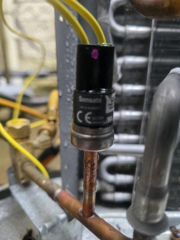 Responded to callback for air conditioning system installed in October that would not operate when first turned on for the season. Upon arrival, conducted thorough system inspection and diagnostic evaluation. Examined indoor unit components including evaporator coil assembly, refrigerant line connections, and control wiring. Verified proper installation of temperature sensors on copper refrigerant lines and checked all electrical connections at control board. Inspected outdoor condensing unit for proper operation and refrigerant circuit integrity. System startup sequence was evaluated, and all safety controls were tested. Documented equipment condition with photographs showing sensor placement on suction line, evaporator coil assembly, and refrigerant piping configuration. Resolved operational issue and verified proper system function with adequate airflow and cooling output.