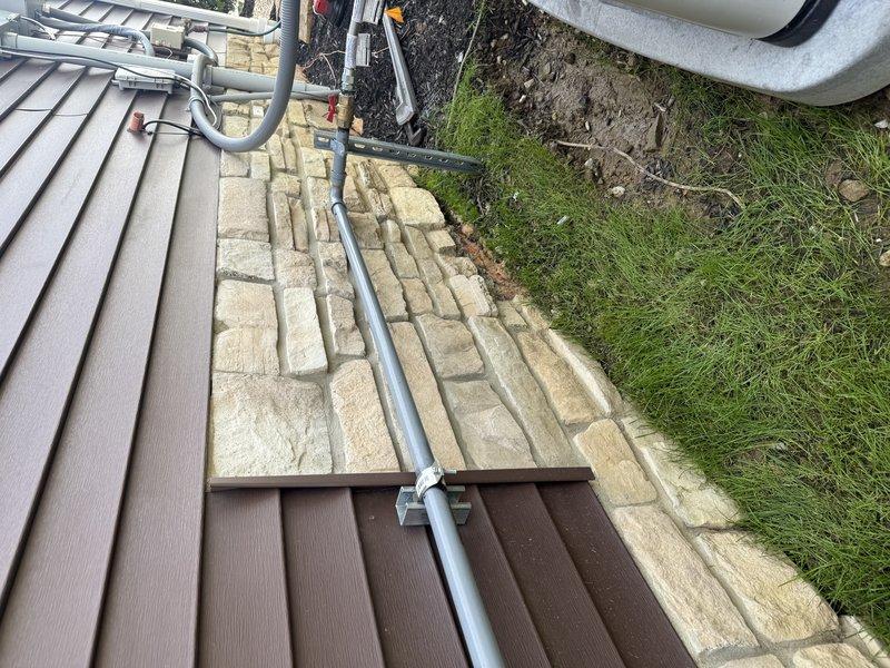 Responded to failed inspection callback for active gas leak at shut-off valve. Upon arrival, identified improper plastic support strap on gas piping that required replacement per code requirements. Replaced non-compliant plastic strap with appropriate metal support hardware to secure gas line properly. Verified brass ball valve and PVC connections were secure and leak-free at outdoor installation point adjacent to building foundation. Documented corrected installation with photographs for inspection records.