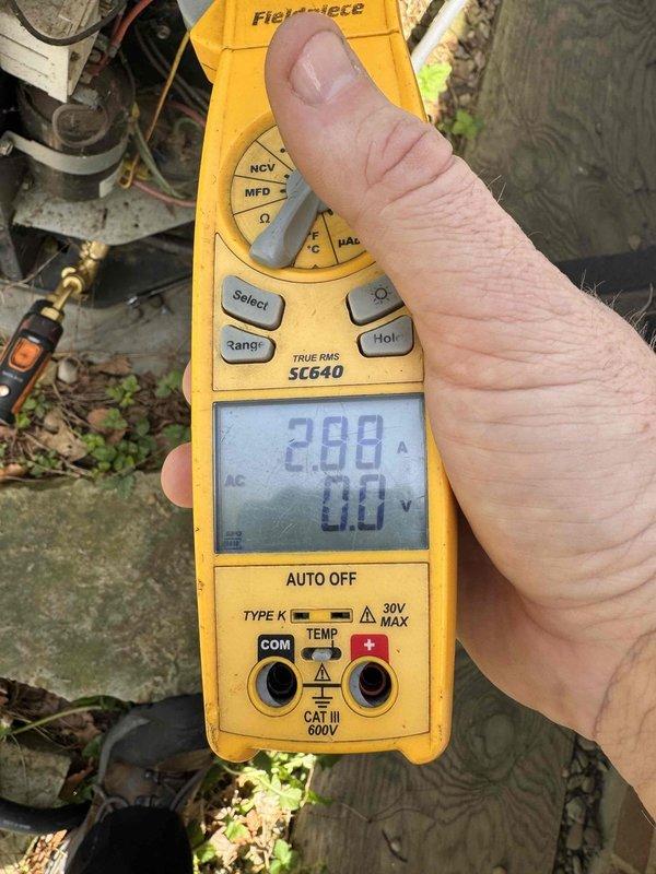 Responded to service call for central air conditioning unit not blowing cold air. Upon arrival, performed comprehensive system diagnostics using digital clamp meter to measure electrical parameters. Recorded compressor amperage draw at 2.88 amps and monitored inrush current readings at 27.4 amps to assess motor and compressor performance. Inspected electrical connections, wiring integrity, and component operation at outdoor condensing unit. Completed full HVAC system service including refrigerant level verification, airflow assessment, and overall system performance evaluation. All measurements indicated proper electrical function within manufacturer specifications. System restored to normal cooling operation and tested for proper temperature differential across evaporator coil.