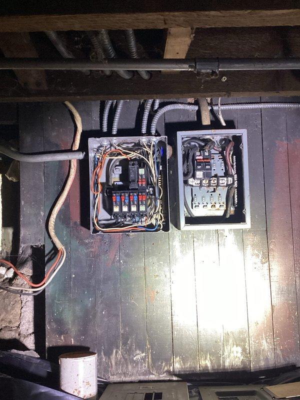Responded to emergency no-power call at century-old residential property experiencing significant power loss affecting half of downstairs circuits and complete loss of power to entire upper floor. Upon arrival, accessed electrical panels located in basement crawl space and performed comprehensive diagnostic evaluation of dual panel system. Inspection revealed multiple circuit breaker failures and compromised wiring connections consistent with aging electrical infrastructure. Identified failed breakers, tested voltage across affected circuits, and traced power distribution issues through both panel boxes. Reset tripped breakers, verified proper electrical loads, and restored power to all affected areas of the residence. Documented existing conditions of vintage electrical system with photographic evidence showing panel configuration, wiring routes through floor joists, and overall basement electrical setup for future reference and recommended follow-up maintenance.