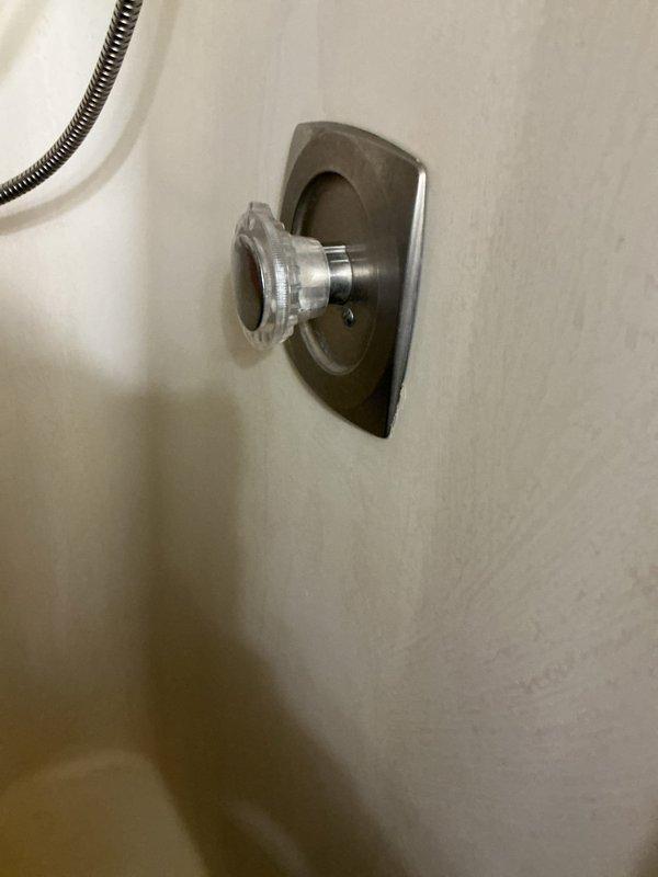 Replaced shower control knobs and handles in two bathroom locations. Installed new chrome-finished trim plates, control valves with porcelain accent pieces, and verified proper operation of all fixtures including tub spout and diverter mechanisms.