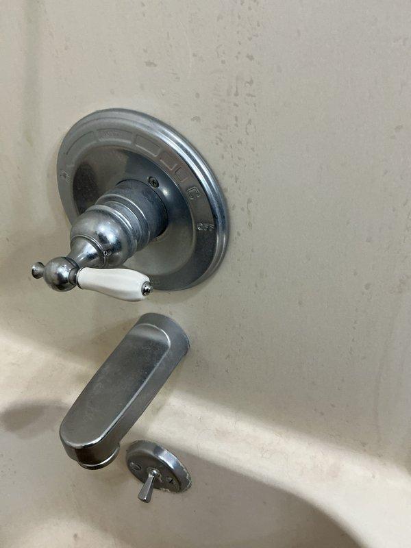 Replaced shower control knobs and handles in two bathroom locations. Installed new chrome-finished trim plates, control valves with porcelain accent pieces, and verified proper operation of all fixtures including tub spout and diverter mechanisms.