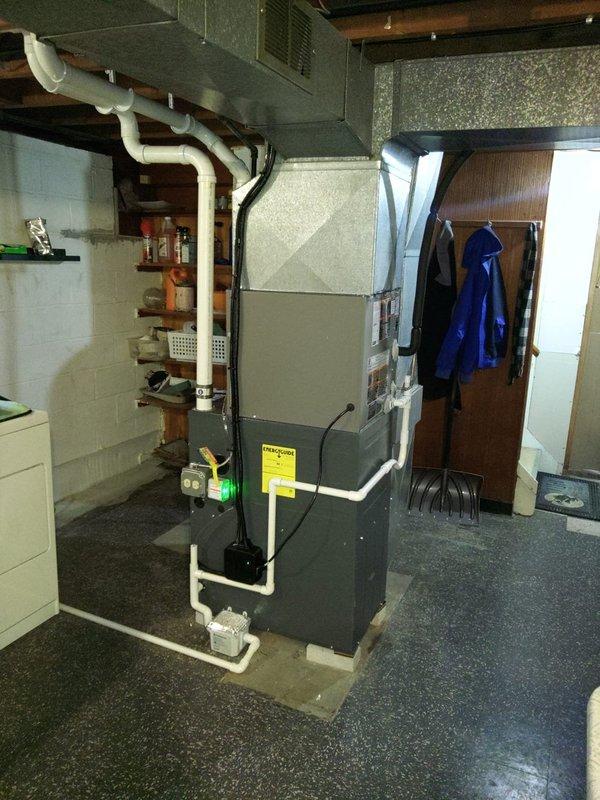 Completed add-on air conditioning system installation including new evaporator coil integration with existing furnace system. Installed 20-amp fused disconnect at outdoor condensing unit location with Littelfuse components for proper electrical protection. Interior evaporator coil mounted to furnace cabinet with refrigerant line connections routed through basement foundation. System prepared for final electrical circuit connection scheduled for completion during follow-up visit.
