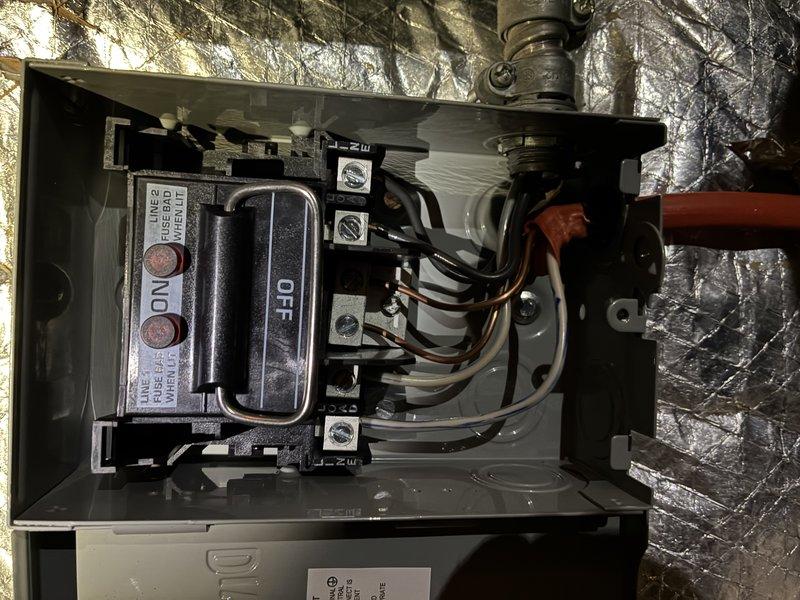 Diagnosed HVAC system with inoperative blower and discovered blown 30-amp fuses supplying power to the blower motor. Upon further inspection, identified heat damage to the electrical disconnect box, indicating excessive current draw or poor connections. Measured electrical current at 52 amps using clamp meter, confirming overload condition. Determined blower motor module failure as root cause of fuse failure and heat damage. Ordered replacement blower motor module under warranty coverage and new disconnect box as non-warranty repair. Coordinated parts delivery and scheduled follow-up installation after components arrived. Documented electrical measurements and heat damage with photographs for warranty claim and customer records.