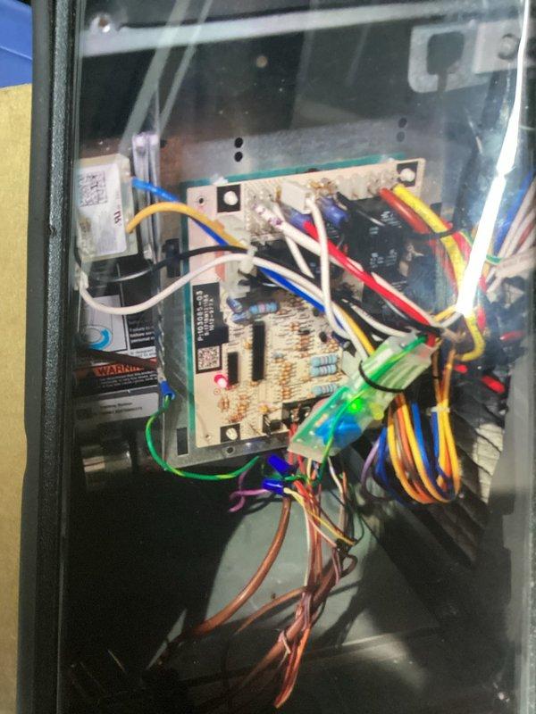 Performed routine maintenance tune-up on 7-year-old air conditioning system, inspecting electrical components including control board, wiring connections, and fuse assembly. Verified proper operation of all system controls, documented equipment condition with photos showing TR25R fuses and main circuit board with connected relay modules, and confirmed unit is functioning within normal parameters.
