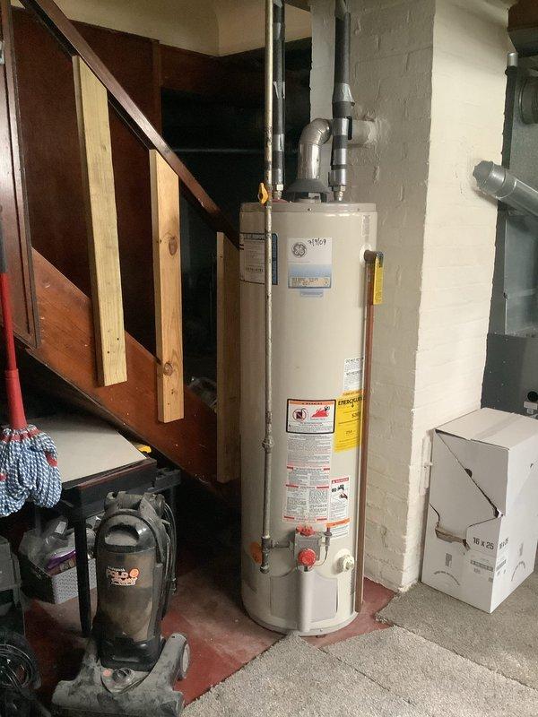 Responded to service call for dripping faucet and utility sink installation request. Upon arrival, assessed existing plumbing infrastructure in basement area near water heater and utility space. Inspected overhead piping system including insulated water supply lines with metal fittings and T-junction connections visible in exposed ceiling joists. Evaluated dripping faucet issue and determined repair requirements. Provided customer with recommendations for new utility sink installation, including optimal placement considerations based on existing plumbing configuration and available workspace in basement utility area.