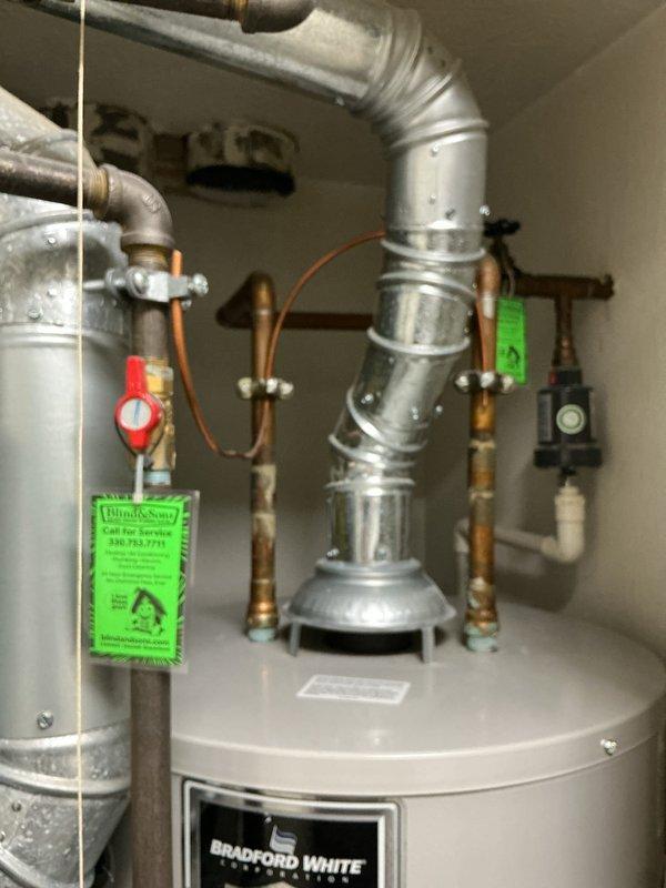 Conducted comprehensive on-site evaluation of existing Bradford White residential water heater installation to provide replacement estimate. Assessed current unit configuration including copper supply line connections, brass fittings, pressure relief valve piping, and exhaust flue venting system. Inspected all shut-off valves, pressure regulators, and control devices for proper operation and code compliance. Documented existing plumbing infrastructure, ductwork connections, and mechanical space constraints. Photographed installation details including hot and cold water line routing, valve assemblies, and ventilation components to prepare accurate replacement proposal.