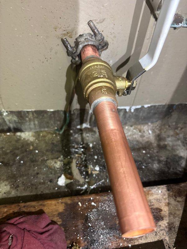 Replaced the main water shut-off valve at the service entry point with a new brass ball valve featuring a yellow handle for improved accessibility and operation. Installed an additional ball valve downstream of the water meter to provide secondary shut-off capability for the building's plumbing system. All copper pipe connections were properly fitted using compression joints and sealed with appropriate thread tape to ensure leak-free operation and compliance with plumbing codes.