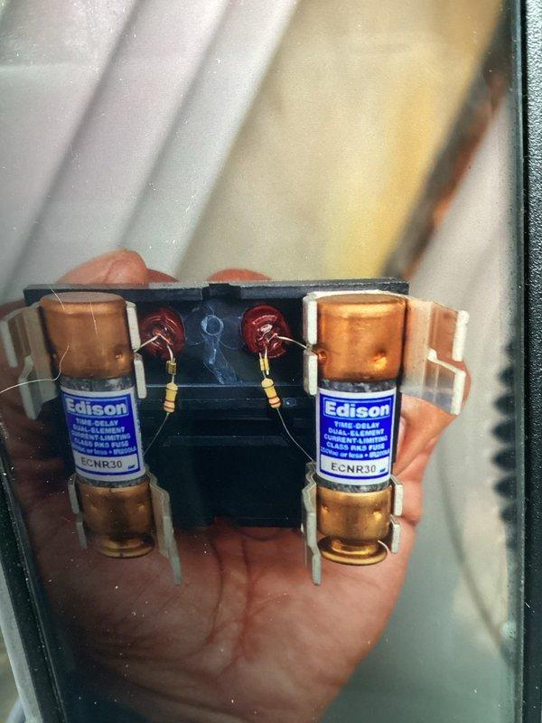 Completed annual cooling maintenance on one-year-old air conditioning system. Inspected electrical components including Edison brand ECNR30 fuses and control boards, verified proper connections and wiring integrity, and documented system condition through photographs. All components operating within normal parameters with no issues identified during this routine preventive maintenance visit.