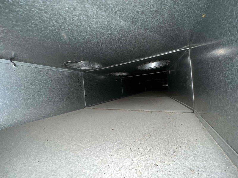 Completed residential duct cleaning service for HVAC system covering up to 14 vents as part of maintenance plan. Pre-service inspection revealed significant dust and debris accumulation throughout the ductwork system, with visible buildup on interior surfaces and metal flooring of rectangular supply ducts. Performed comprehensive cleaning of all accessible ductwork, removing accumulated particulate matter and contaminants from supply and return vents to improve air quality and system efficiency.