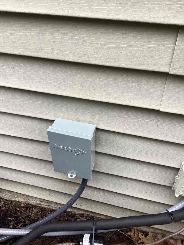 Completed startup and commissioning of newly installed air conditioning system. Verified proper installation of exterior line set connections, diverter box mounting, and electrical conduit routing along building exterior. System tested and confirmed operational, ready for customer use.