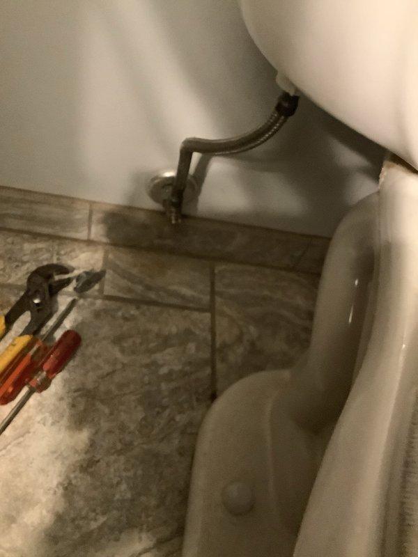 Responded to service call for malfunctioning toilet shut-off valve and broken flush handle. Upon arrival, found customer had shut off main water supply to entire house due to faulty fixture components. Replaced defective angle stop valve on water supply line to restore proper shut-off functionality at the fixture level. Installed new Sloan-style flush handle assembly to replace broken actuator mechanism. Restored water supply to house, tested toilet for proper fill, flush operation, and verified no leaks at connections. Left fixture fully operational with customer able to control water supply at toilet level.