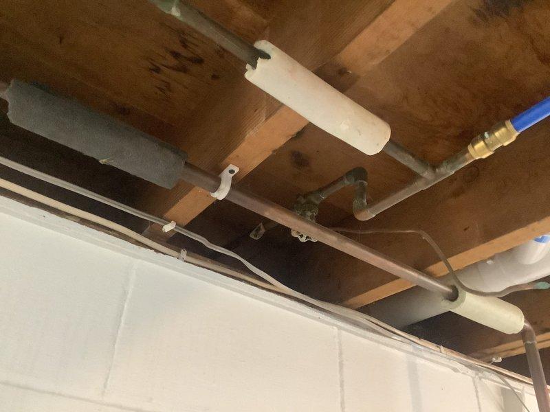 Completed tanked water heater flush and fill service to remove sediment buildup and restore efficient operation. Inspected plumbing infrastructure including exposed ceiling-mounted pipes, valves, and fittings during service. Provided estimate for hose spigot replacement and ball valve installation as requested by customer.