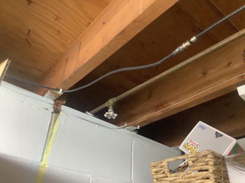 Completed tanked water heater flush and fill service to remove sediment buildup and restore efficient operation. Inspected plumbing infrastructure including exposed ceiling-mounted pipes, valves, and fittings during service. Provided estimate for hose spigot replacement and ball valve installation as requested by customer.