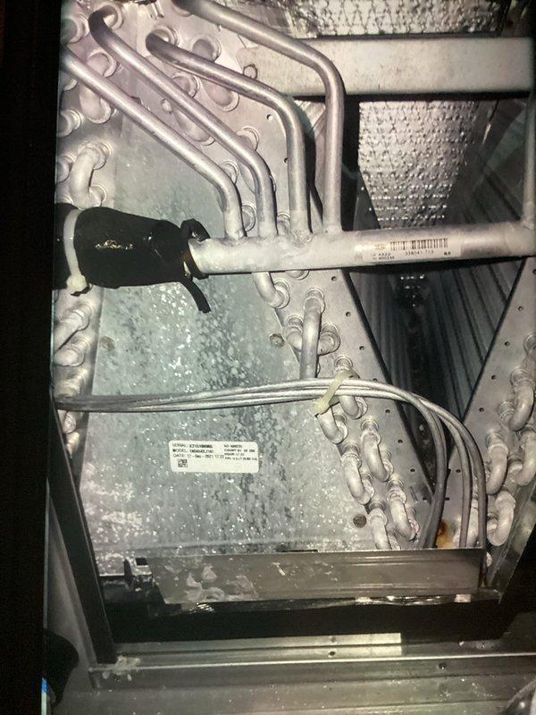Completed AC tune-up on 5-year-old system and discovered evaporator coil with severe frost buildup indicating restricted airflow or low refrigerant charge. Documented frozen coil condition with temperature readings using digital thermometer showing significant temperature differential. Recommended further diagnostics to determine root cause of icing issue, which may include checking refrigerant levels, verifying proper airflow across coil, and inspecting for potential restrictions in the system.