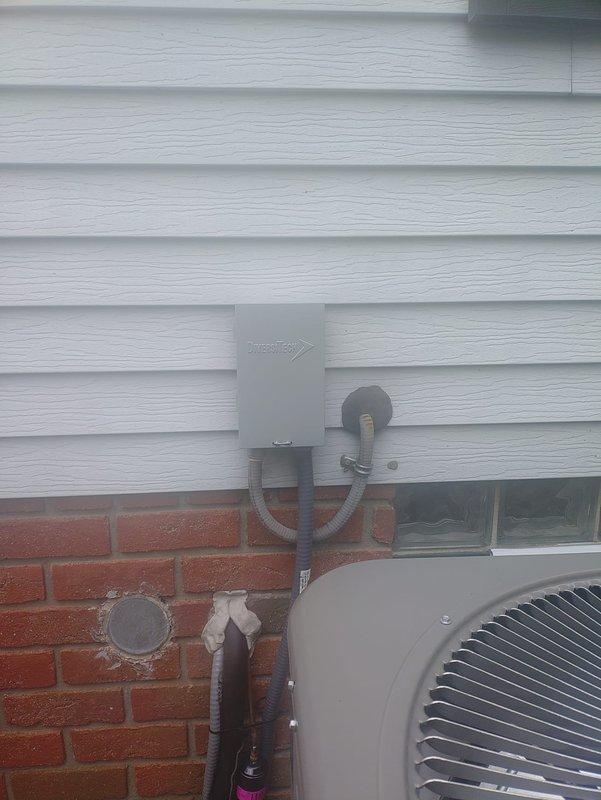 Completed full HVAC system installation including 90% efficiency furnace, air conditioning unit, and humidifier. Installed outdoor condensing unit on exterior pad with proper electrical disconnect and conduit routing, ensuring compliance with manufacturer specifications and local codes. Upgraded electrical protection with dual-element Class J time-delay fuses rated at 35 amps and 250 volts for equipment safety and proper circuit protection.