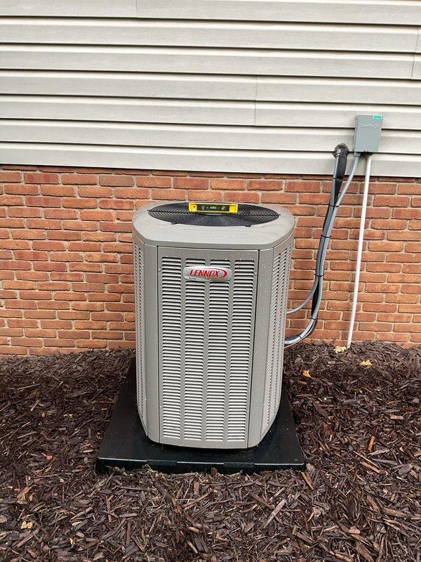Responded to warranty call for recently installed Lennox air conditioning unit requiring leveling adjustment. Upon arrival, verified unit was unlevel using spirit level on condenser fan grille. Adjusted hexagonal condenser unit positioning on pad to achieve proper level in all directions, ensuring optimal compressor operation and refrigerant flow. Confirmed unit stability on protective pad and verified all refrigerant lines and electrical connections remained secure following adjustment.