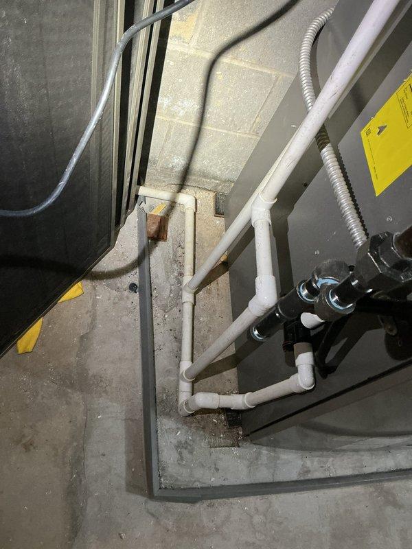 Completed installation of Bradford White tanked water heater system in basement mechanical room. Removed existing water heating equipment and installed new tank-style unit with complete copper supply and discharge piping. Configured PVC drainage system with proper venting and condensate removal connections. Mounted circulation pump assembly on top of water heater tank with appropriate copper pipe connections and isolation valves. Installed manifold distribution system on concrete block wall with multiple shutoff valves for zone control. Ran new copper supply lines with shutoff valves, pressure relief valve, and proper code-compliant connections. Tested all connections for leaks, verified proper pump operation, and ensured adequate drainage flow through PVC waste system. System commissioned and left in full working order.