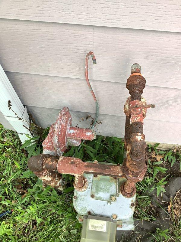 Responded to service call for non-functioning natural gas outdoor light fixture. Upon arrival, inspected gas meter assembly and traced gas line to exterior lantern-style light mounted on post. Found heavily corroded gas piping throughout the system, with extensive rust on valves, connections, and fittings at meter location. The outdoor light fixture exhibited severe deterioration with rusted metal frame, heavily soiled glass panels, and accumulated debris inside the enclosure indicating extended exposure without maintenance. Assessed the gas supply line integrity and connections leading to the fixture. Performed necessary repairs to restore proper gas flow and functionality to the outdoor gas light, ensuring all connections were secure and system was operating safely per code requirements.