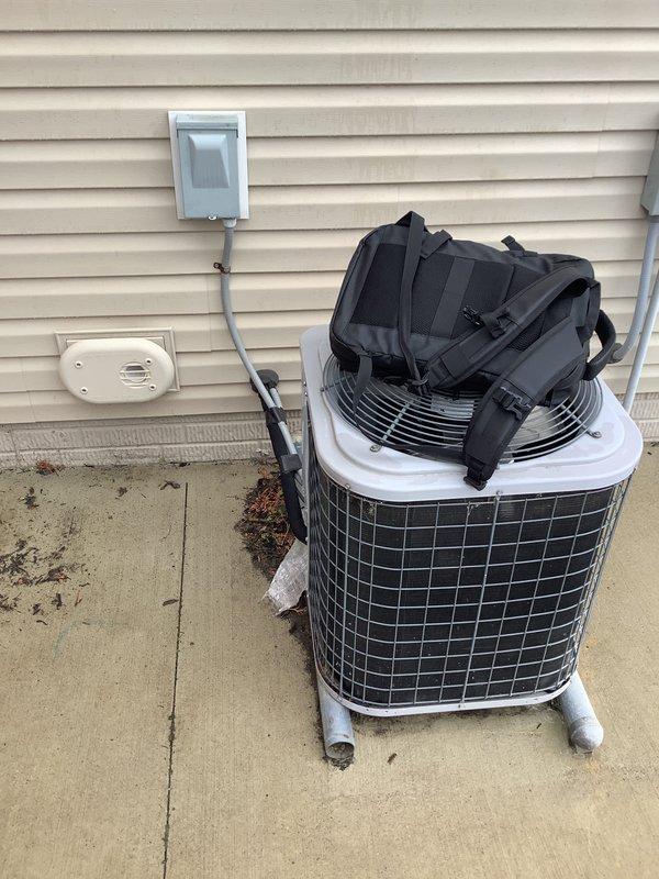 Conducted site evaluation for residential air conditioning system replacement and relocation. Assessed existing 10-year-old outdoor condenser unit currently positioned on concrete pad adjacent to structure with vinyl siding, documented electrical disconnect configuration and refrigerant line routing. Provided comprehensive estimate for system relocation options and equipment upgrade to higher-capacity unit to meet enhanced cooling requirements.