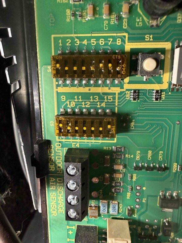 Completed routine maintenance on a 4-year-old air conditioning system. Inspected outdoor condenser coil and found heavy accumulation of dust, dirt, debris, and organic material restricting airflow through the fins. Examined control board and verified DIP switch settings and electronic components for proper operation. System operational at time of service.