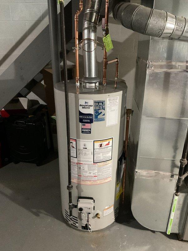Removed existing water heater and installed new 40-gallon Bradford White residential unit. Brought installation up to current code compliance by adding thermal expansion tank, proper electrical bonding, and new gas shut-off valve. Connected all copper supply and discharge lines with appropriate fittings and heat traps. Completed all plumbing connections, tested system for proper operation and leak-free performance. Hauled away old unit and registered new water heater with manufacturer for 8-year warranty coverage.