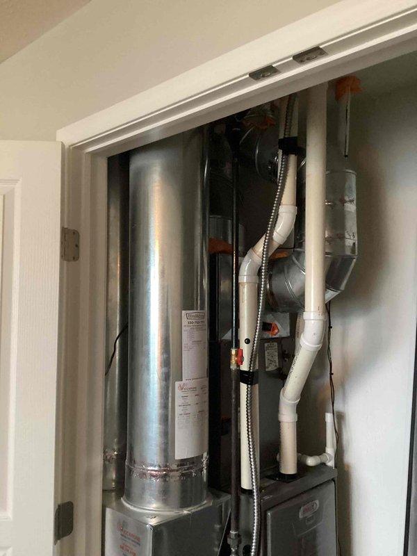 Completed annual air conditioning tune-up on a ten-year-old residential system located in utility closet. Performed comprehensive inspection of indoor air handler unit, verified proper electrical connections, cleaned condensate drain line, checked refrigerant levels, and tested system operation. All components found to be functioning within normal parameters with no immediate service needs identified.
