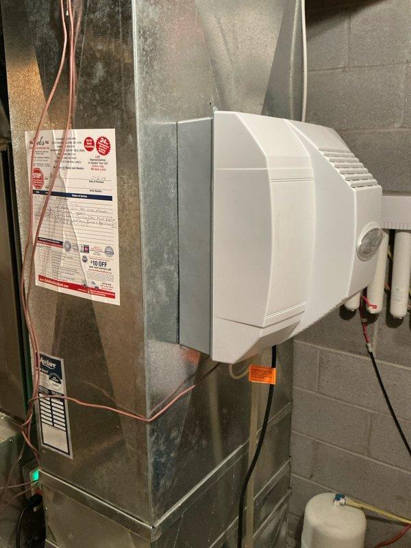 Completed comprehensive estimate for full HVAC system replacement including furnace and air conditioning equipment. Evaluated existing Bryant furnace installation in basement utility area, assessed current ductwork configuration, whole-house humidifier integration, and refrigerant line routing. Documented equipment specifications, condensate drainage system with PVC piping, venting arrangements, and overall system layout to provide accurate replacement proposal.