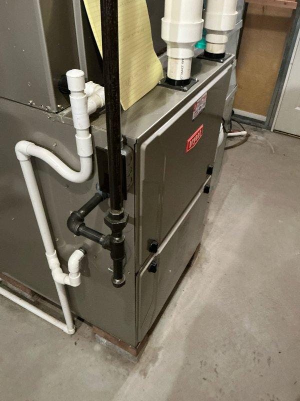 Completed comprehensive estimate for full HVAC system replacement including furnace and air conditioning equipment. Evaluated existing Bryant furnace installation in basement utility area, assessed current ductwork configuration, whole-house humidifier integration, and refrigerant line routing. Documented equipment specifications, condensate drainage system with PVC piping, venting arrangements, and overall system layout to provide accurate replacement proposal.