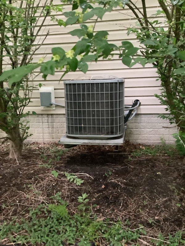 Completed full HVAC system installation including 80% efficiency furnace with 600 CFM air handler in basement utility area and matching outdoor air conditioning condenser unit. Indoor unit installed on concrete pad with proper ductwork connections and electrical hookups; outdoor condenser positioned on concrete pad against exterior wall with appropriate clearances, electrical conduit run, and landscaping protection in place.