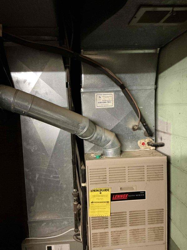 Provided comprehensive estimate for complete HVAC system replacement including both furnace and air conditioning units. Assessed existing Lennox Elite Series furnace in basement utility area and outdoor condensing unit, noting current system configuration, ductwork connections, and existing placement. Documented requirement to relocate outdoor AC unit approximately three feet to the left of current position and addressed disconnect positioning for replacement installation.