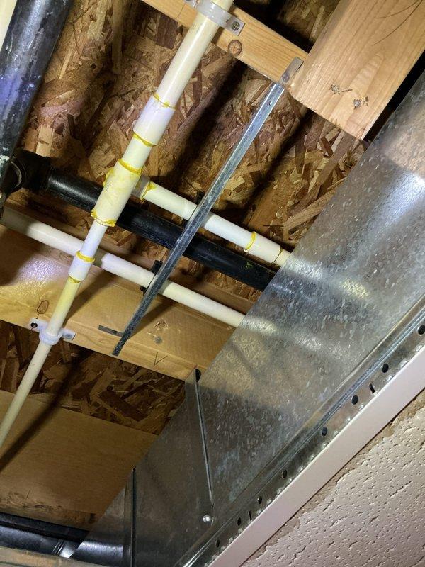 Repaired leaking CPVC water line in basement ceiling at a 3/4" x 3/4" x 1/2" tee fitting with a 3/4" street 90 connection. Reconfigured the piping by installing a 90-degree elbow on the straight run, adding a tee fitting in the middle section, coupling back to the existing 3/4" pipe, and installing a street 90 to complete the final connection. All fittings were properly secured and tested for leaks to ensure system integrity.